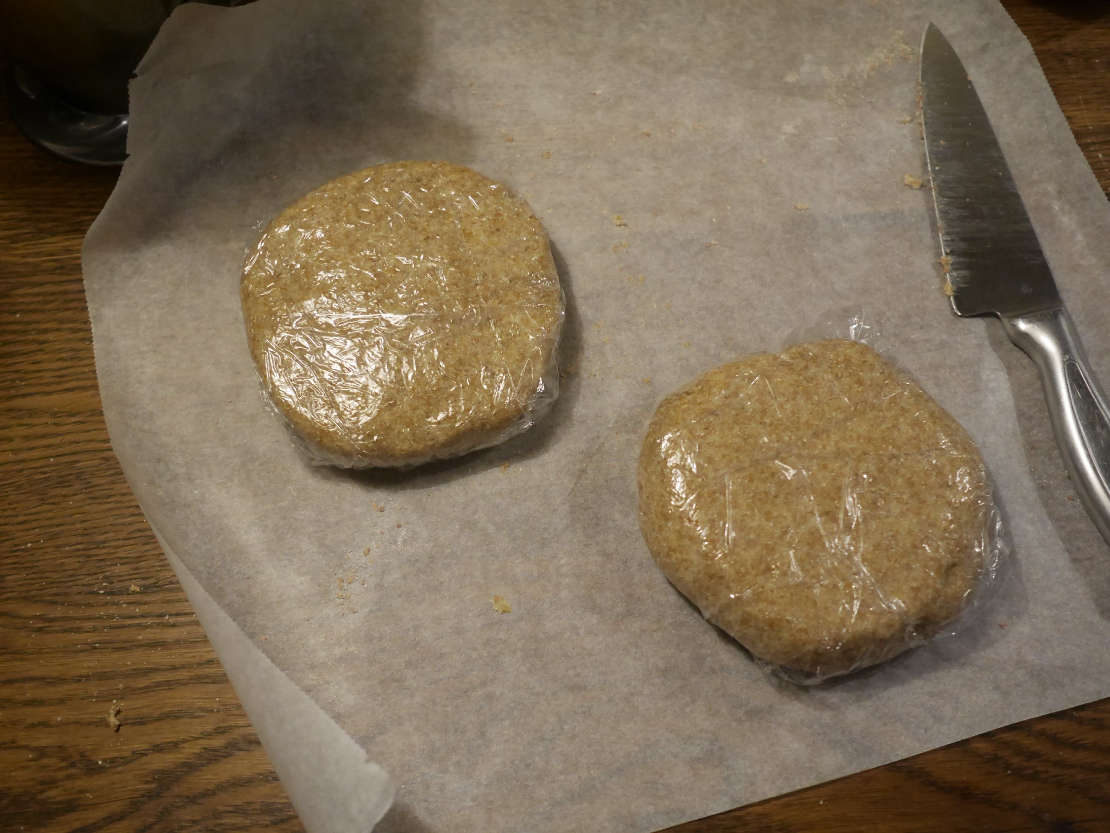 Pie pastry pucks wrapped in cling-wrap.