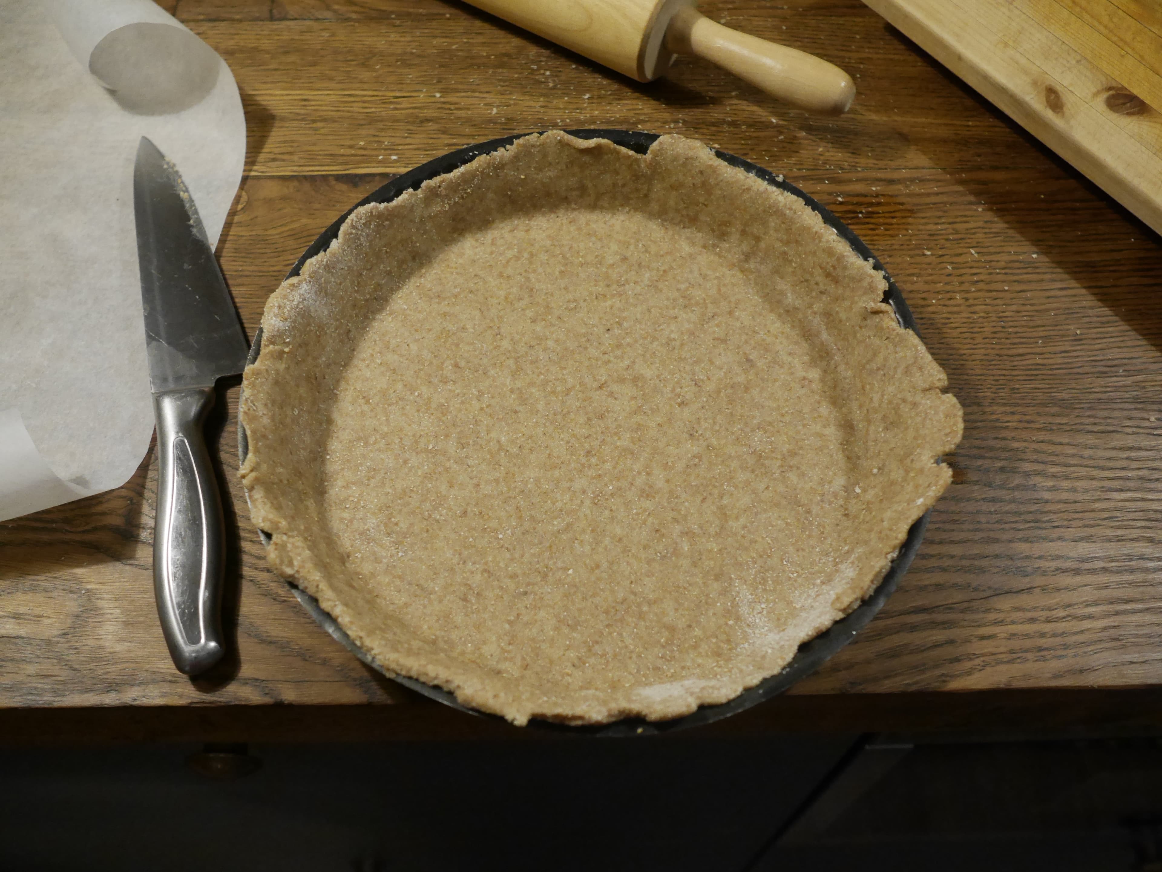 A pie dish lined with pastry.