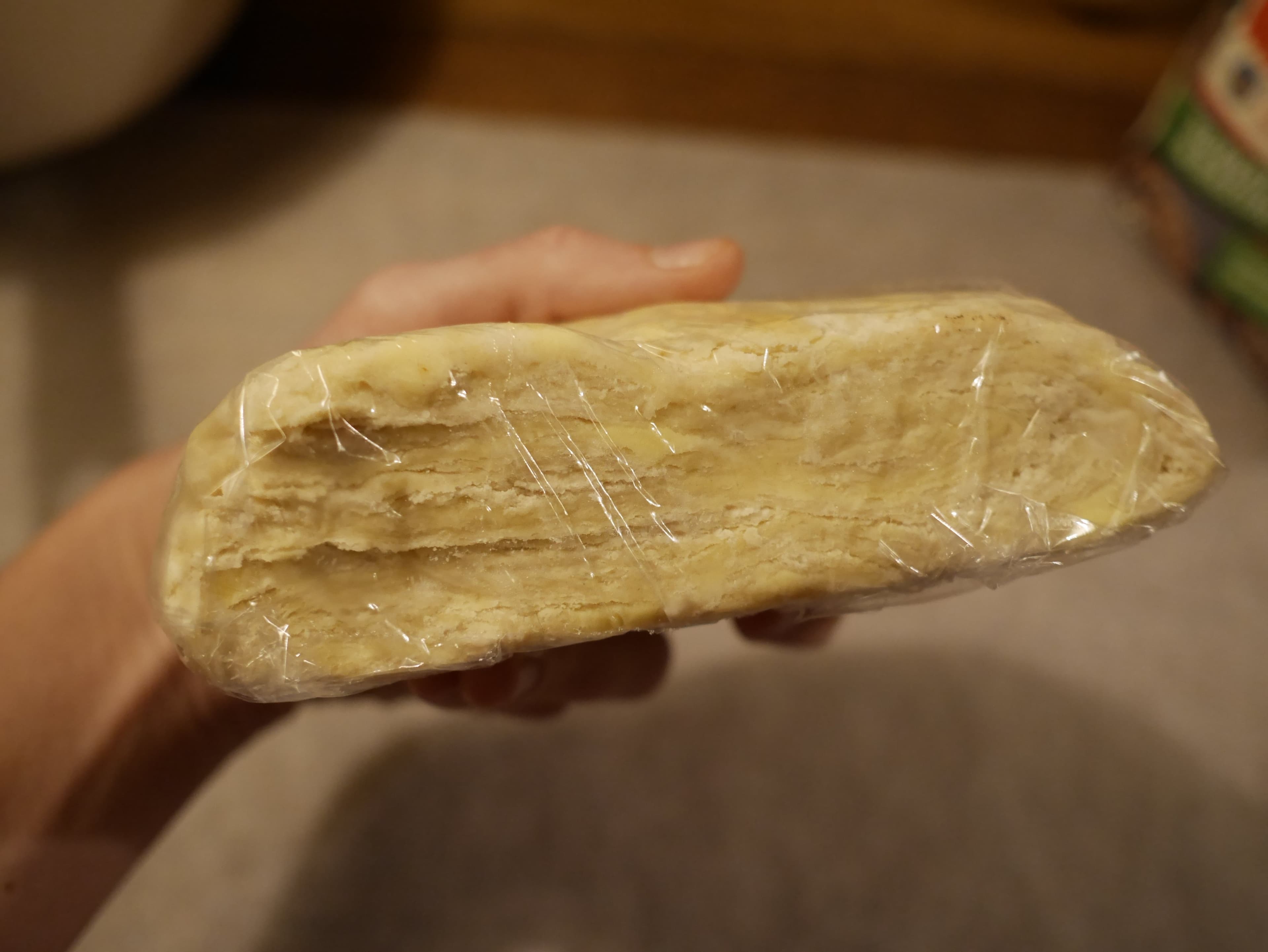 Pie pastry wrapped in cling-wrap.