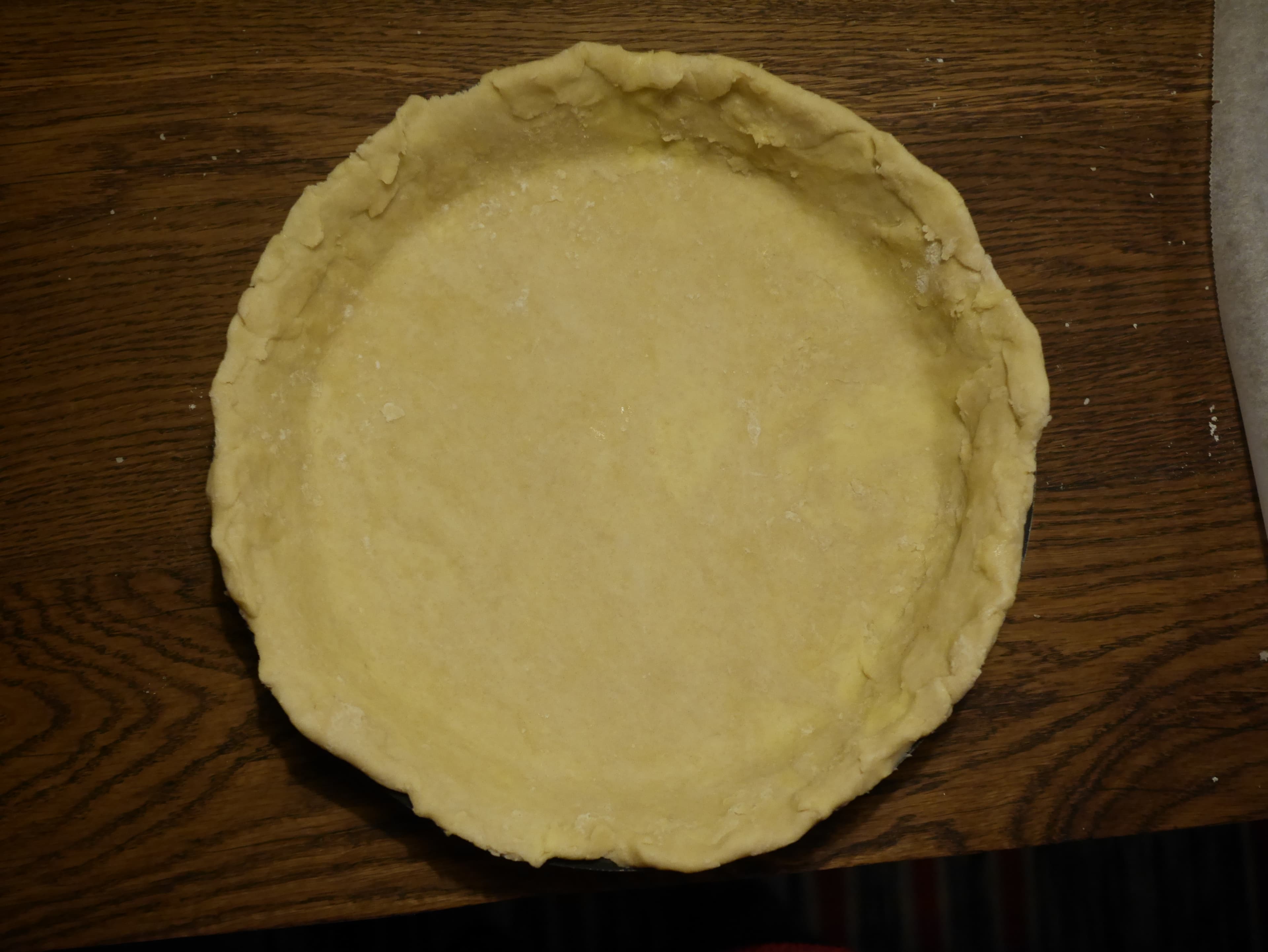 A pie dish lined with pastry.