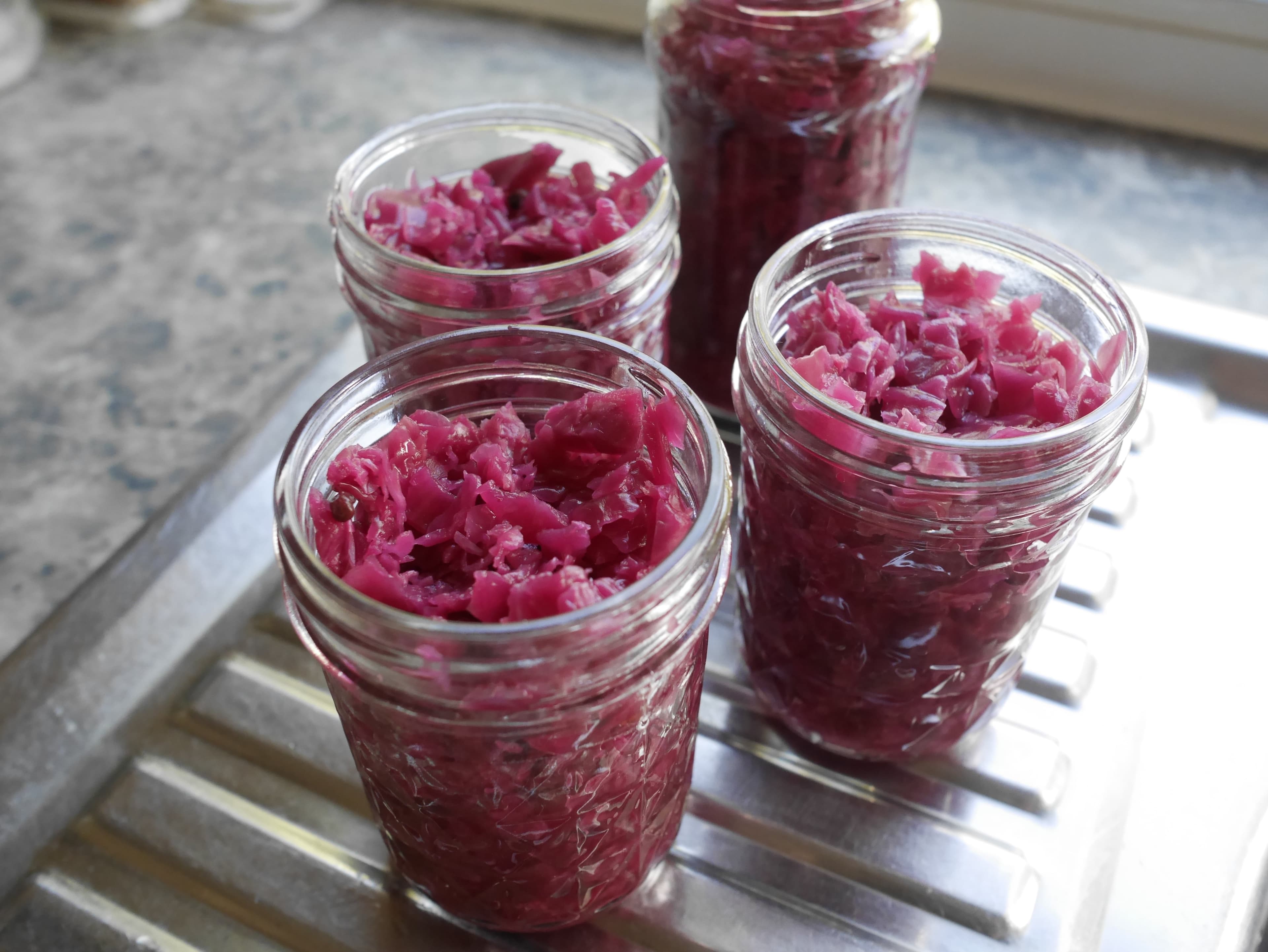 Pink fermented sauerkraut after 22 days, in 4 jars.